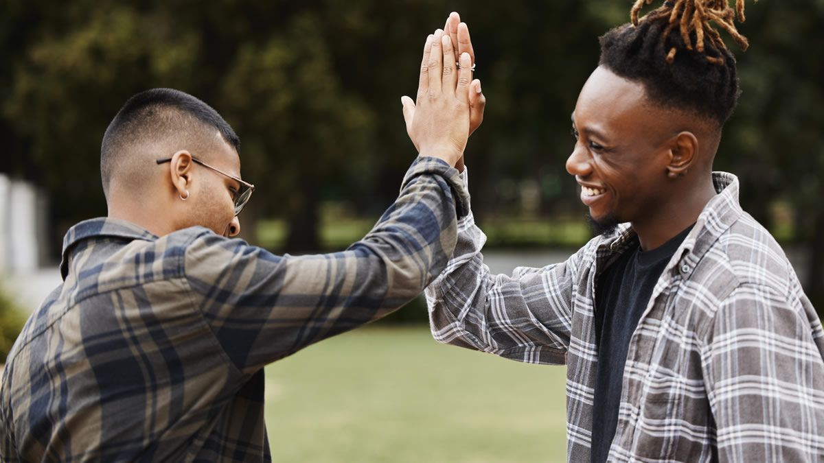 Two young men high five