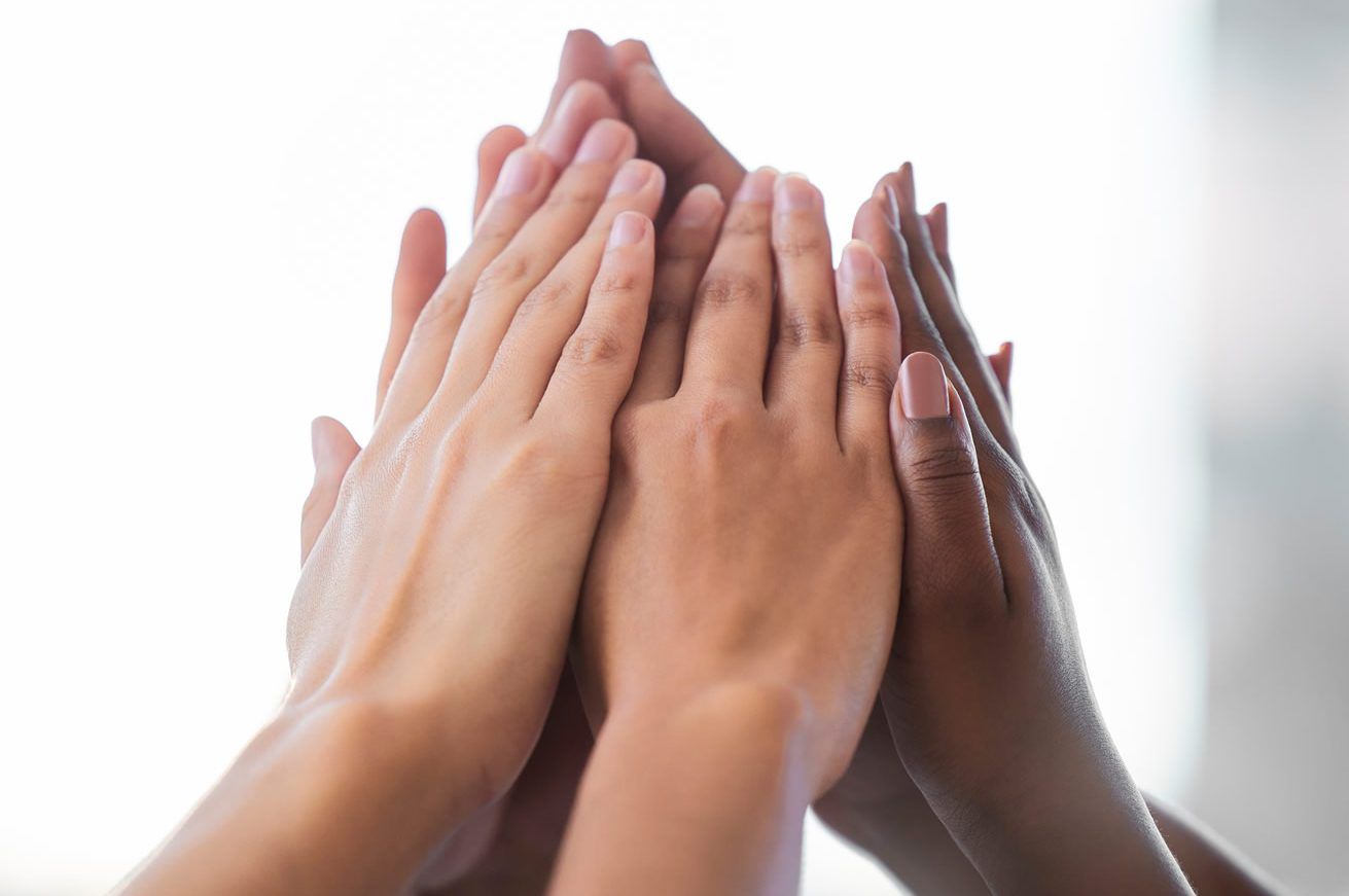 close up of group of hands - high five